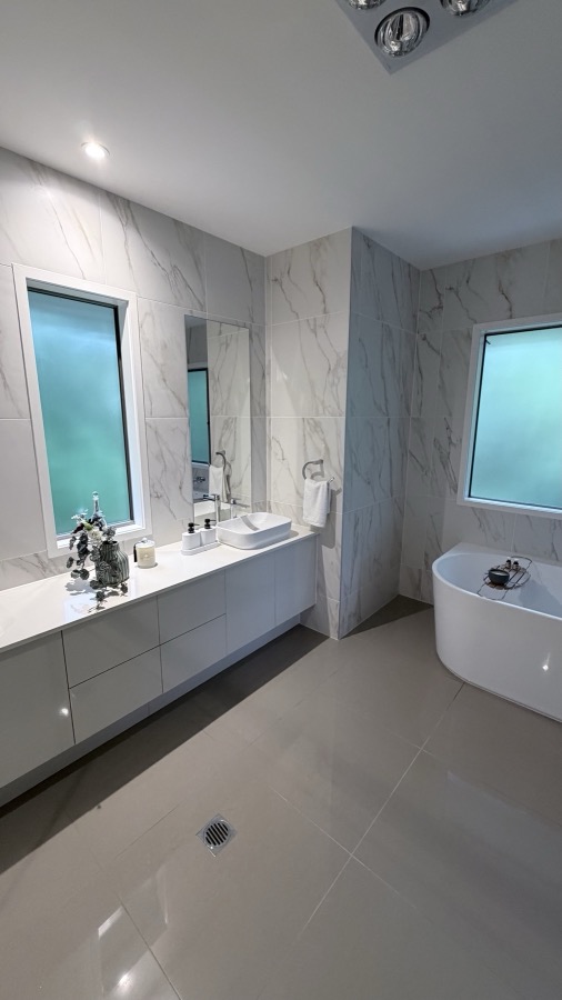 Marble bathroom with freestanding tub after a FYS Cleaning Services clean, Brisbane home